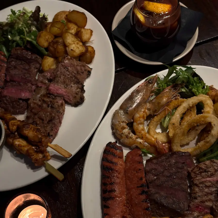 Mixed grill, seafood and cocktails shared around the table
